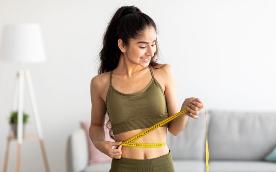 Fit young Indian woman in sports clothes