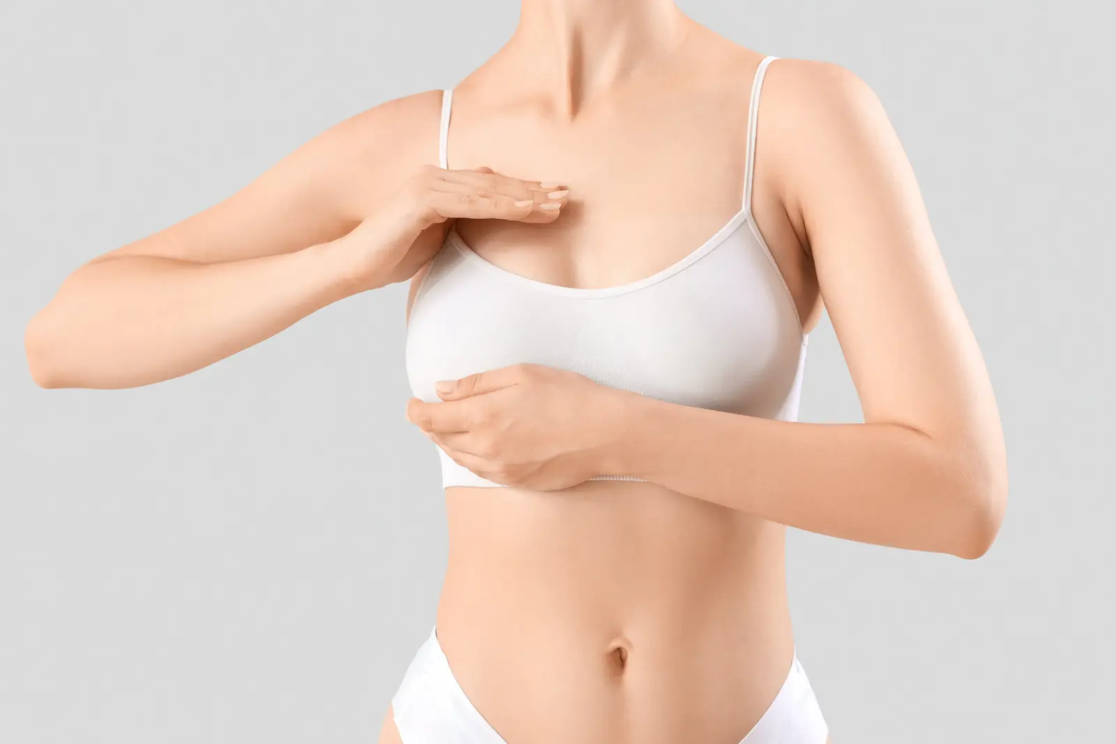Young woman touching her breast